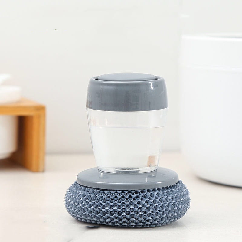 Éponge en silicone grise avec un récipient en plastique transparent et un couvercle gris, conçue pour la vaisselle dans un ensemble de brosse palmier distributeur de savon et de brosse à récurer.