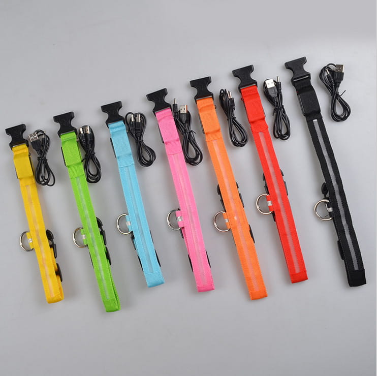 A set of colorful led dog collars in yellow green blue pink orange red and black made of nylon with usb charging cables and reflective strips for night safety and glowing pet leashes.