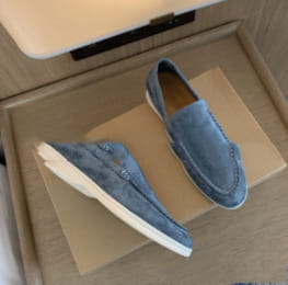 Mocasines de ante azules para hombre con suela de goma blanca, calzado casual, mostrados por el lado trasero.