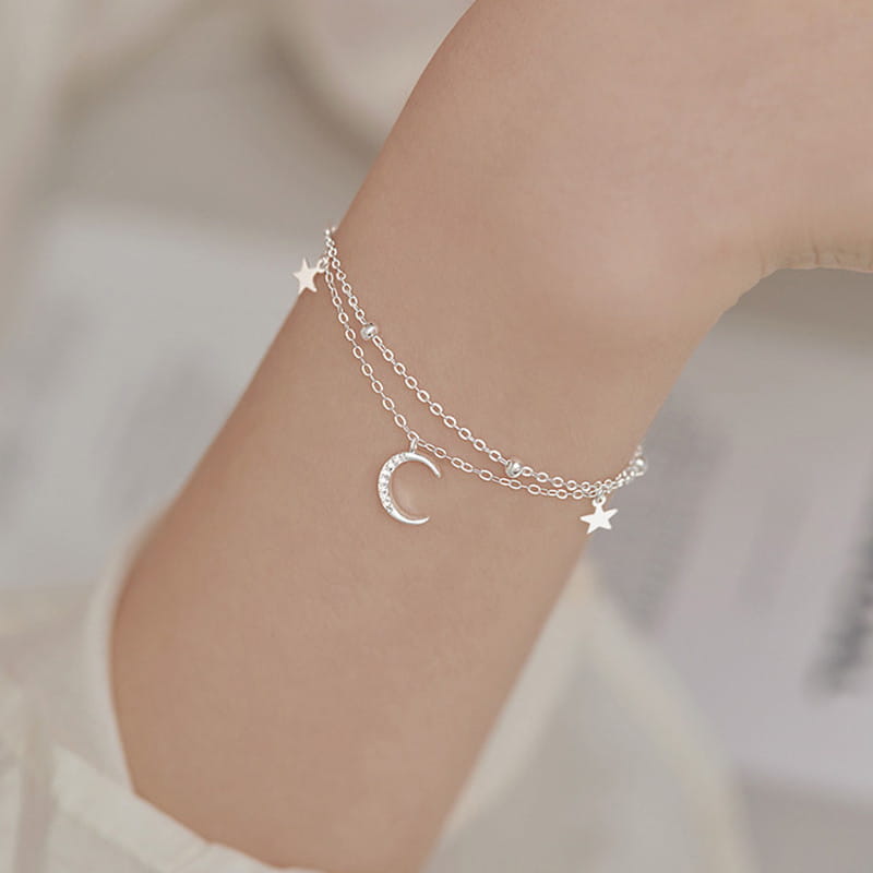 Silver double-layered anklet featuring a crescent moon charm with embedded crystals and small star charms from the double layer silver moon and star crystal anklet bracelet collection.