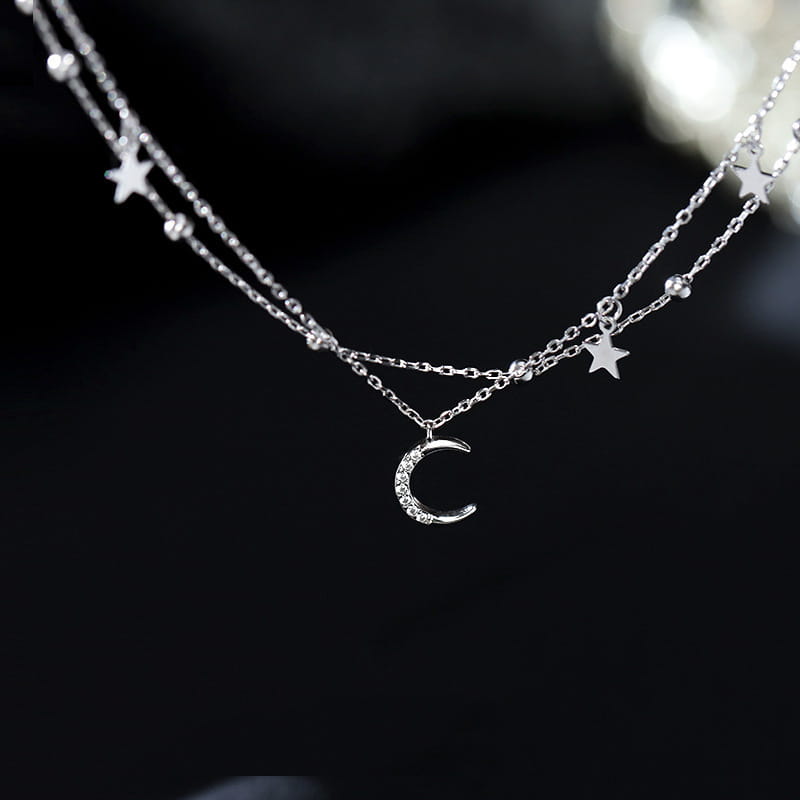 silver double layer anklet bracelet featuring a crescent moon pendant with tiny crystals and delicate star charms on double strands