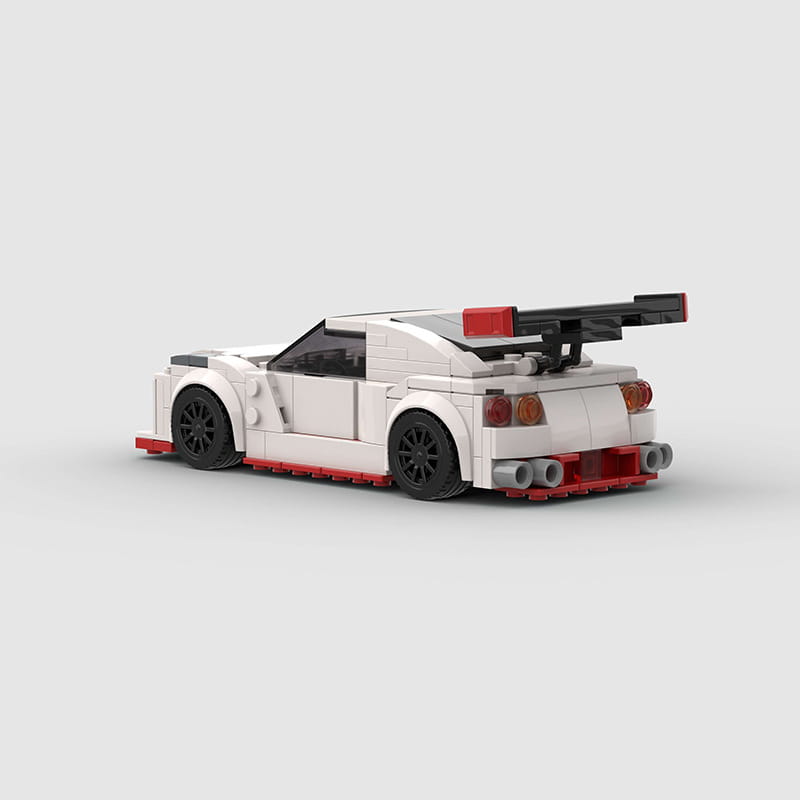 White and red nismo r35 racing car building blocks toy with black wheels and prominent rear spoiler made of 251pcs lego pieces.