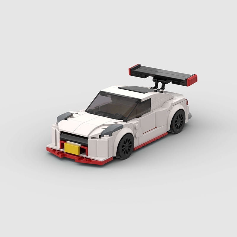 White and red Nismo R35 racing car building blocks toy with black wheels a spoiler and yellow license plate composed of 251 pieces.