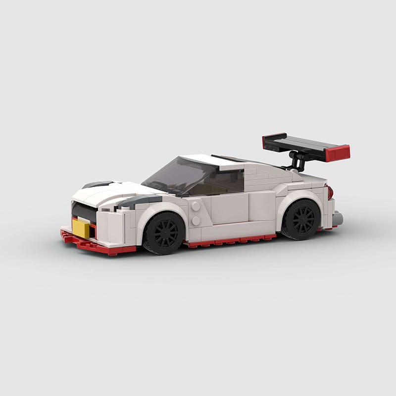 White and red Nismo R35 racing car building blocks toy with black wheels and a rear spoiler made of 251pcs plastic parts.