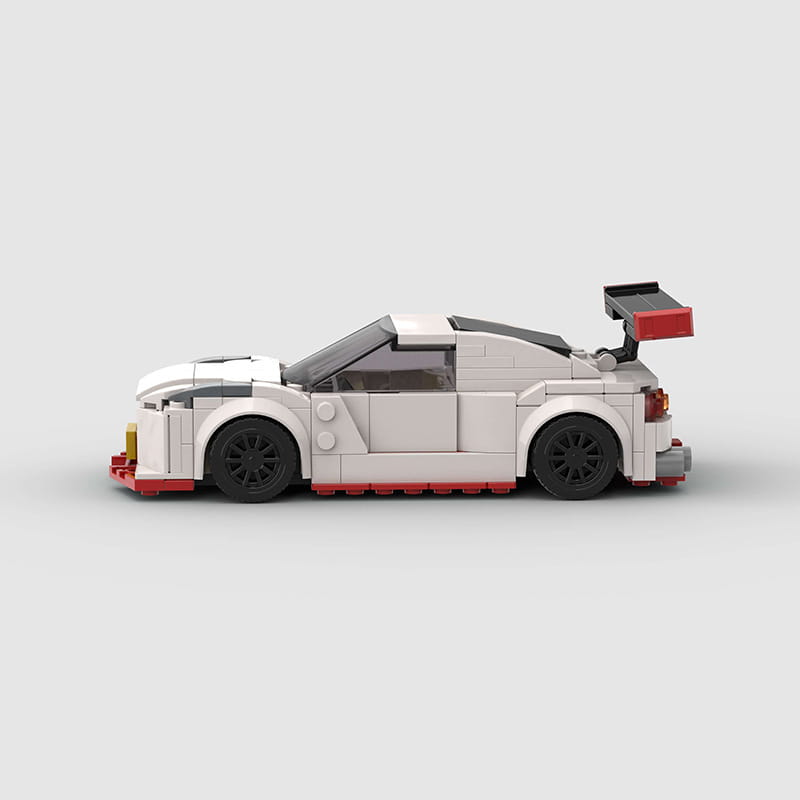 White and red lego Nismo R35 racing car building blocks toy with black wheels and spoiler comprising 251 pieces.