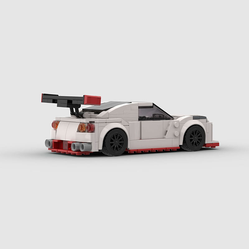 white and red lego nismo r35 racing car building blocks toy with black wheels and a prominent rear spoiler visible from the back side