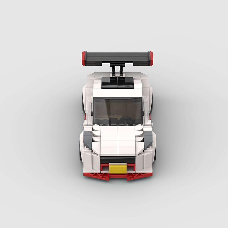 white and red lego nismo r35 racing car building blocks toy with black spoiler gray accents and yellow license plate viewed from the back side