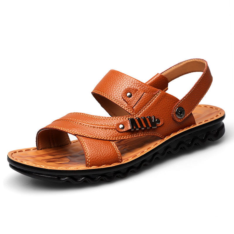 Men’s cowhide leather sandals in tan with black textured soles and adjustable straps featuring metal buckle accents.