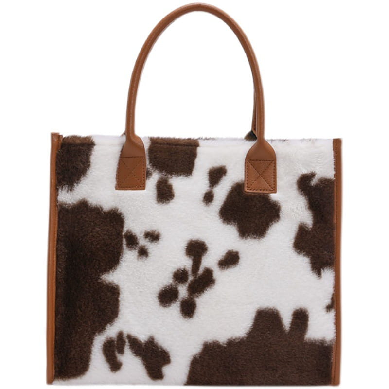 Large capacity leopard print plush tote bag with brown and white cow print faux fur and tan leather handles.