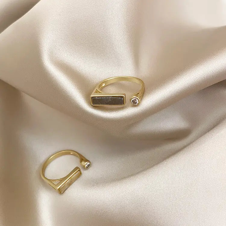 Vintage geometric zircon marble adjustable ring featuring a gold-toned band with a rectangular dark stone and a small clear gemstone accent.