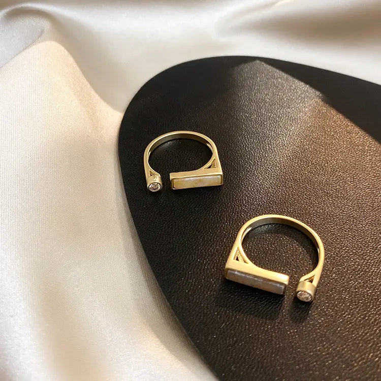 Vintage geometric zircon marble adjustable ring featuring a gold-toned open band with rectangular light-colored stone inlay and small diamond accents on each side.