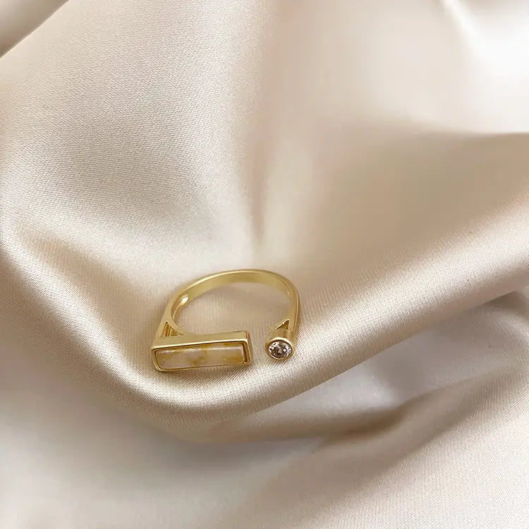 Gold-toned open vintage geometric zircon marble adjustable ring featuring a rectangular translucent stone and a small round gemstone accent.