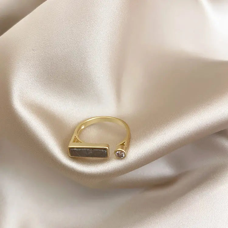 Gold-toned vintage geometric zircon marble adjustable ring featuring a rectangular dark stone and a small round diamond accent.