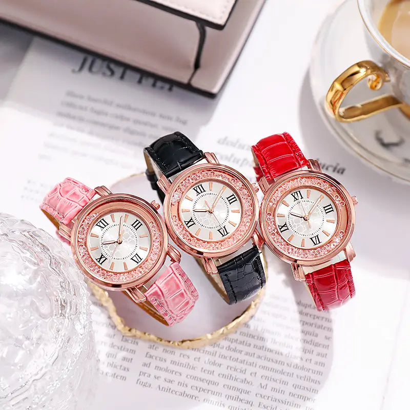 Three elegant rose gold quicksand crystal watches with crystal-encrusted bezels and roman numeral dials featuring pink black and red crocodile-patterned embossed leather straps.