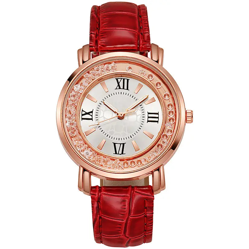 Rose gold quicksand crystal watch with a red crocodile-patterned leather strap and sparkling crystal bezel featuring roman numerals on a white dial.