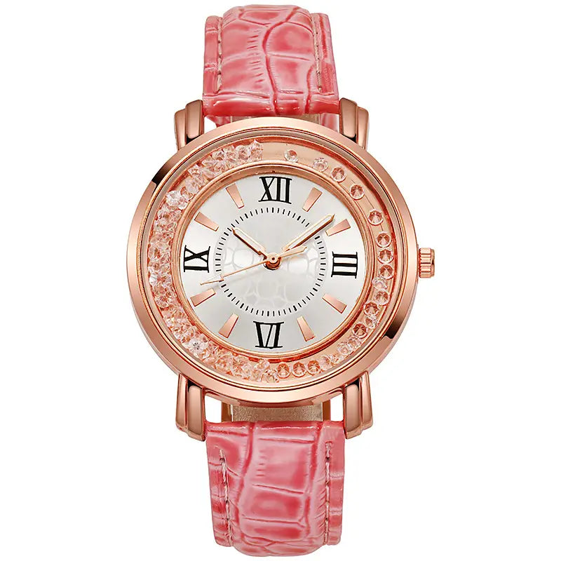 Rose gold quicksand crystal watch with a pink crocodile textured leather strap and a sparkling crystal bezel featuring roman numerals on a white dial.