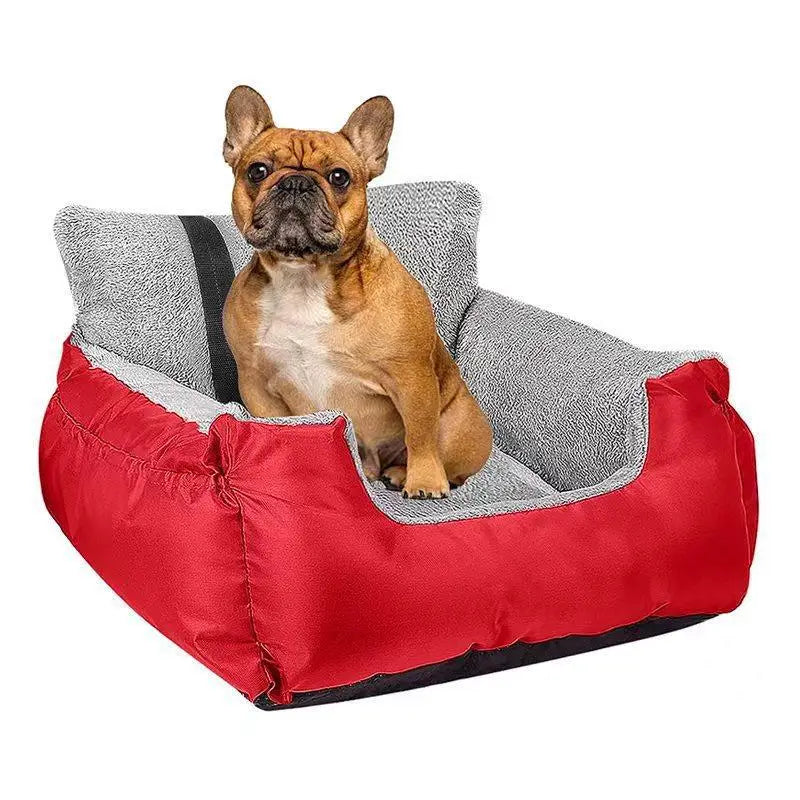 Red and gray plush dog car seat for small pets with a cozy cushioned interior designed for comfort and safety.