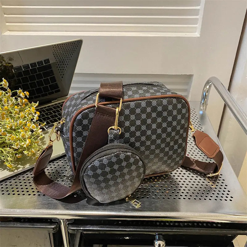 Vintage monogram shell crossbody bag in brown and gray pattern with matching circular coin pouch and gold-tone hardware.