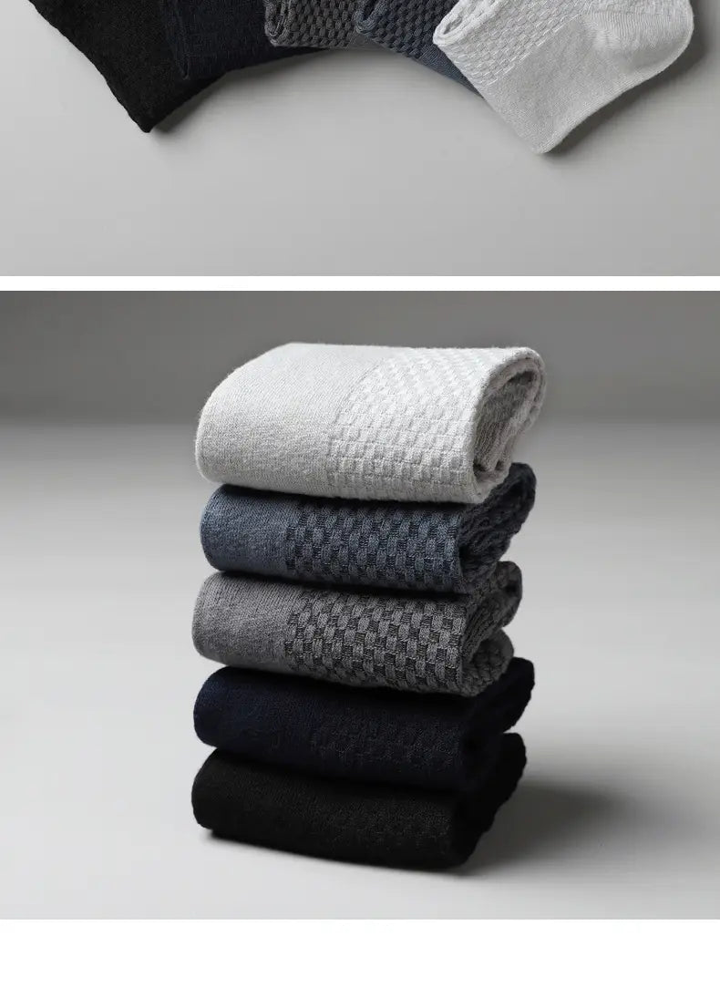 Men bamboo fiber ankle socks 4 pack featuring a stack of neatly folded solid and textured gray tones with a subtle woven pattern on the upper section.