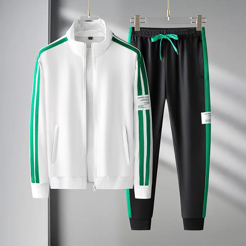 Men track suit zip two piece set green featuring a white and green zip-up jacket with vertical stripes on the sleeves and black pants with matching green side panels and an elastic waistband.