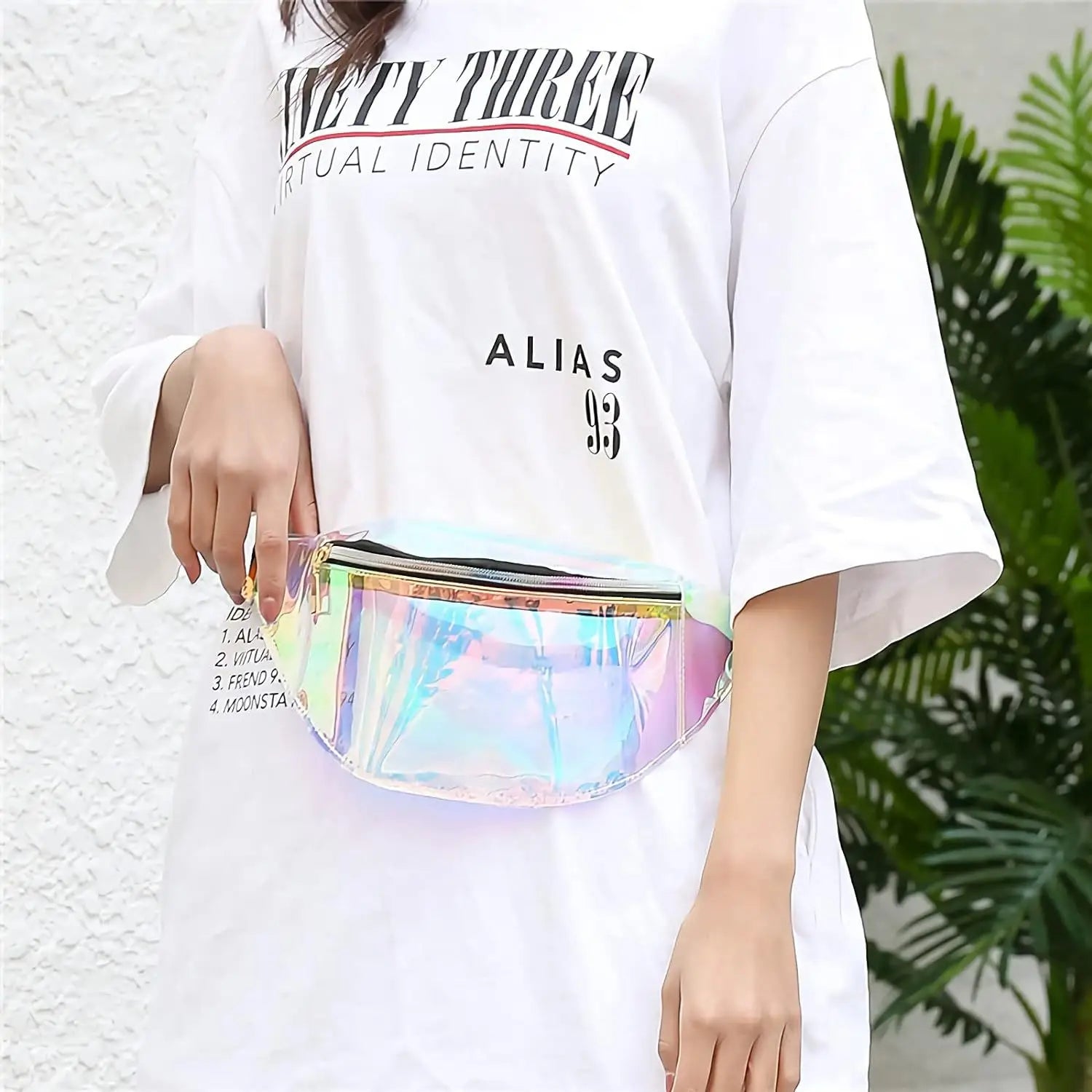 Holographic iridescent TPU waist bag with a transparent rainbow-shifting finish and black zipper designed as a chest satchel.