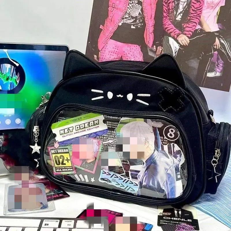 Black cat-ear crossbody messenger bag with a clear ita panel featuring stickers and a printed image of an idol.