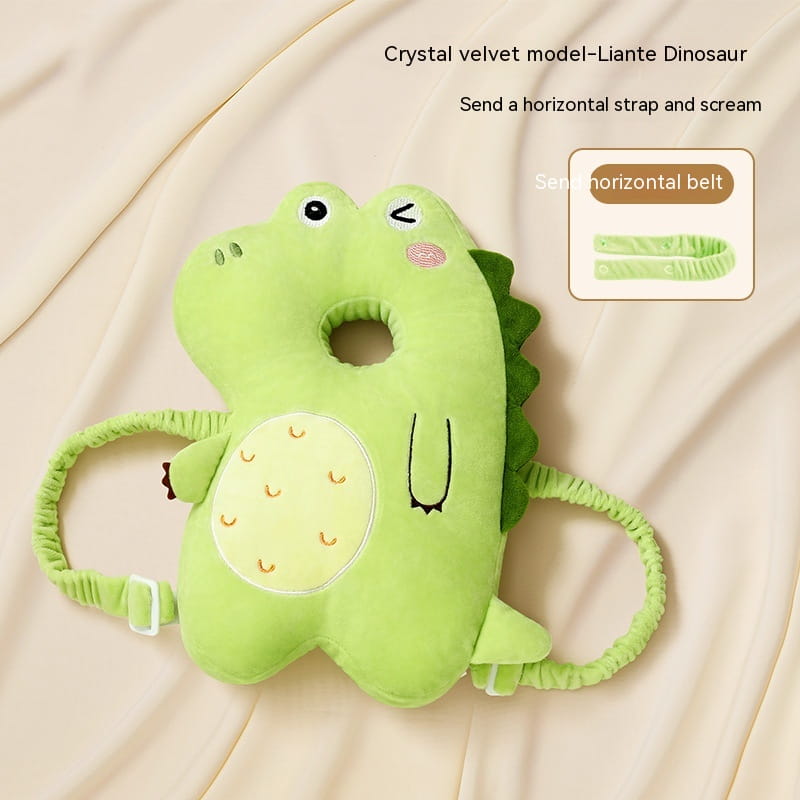 a soft light green plush dinosaur-shaped baby head protector toddler fall protection pillow with a textured velvet finish and embroidered details