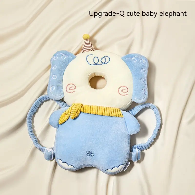 Baby head protector toddler fall protection pillow in soft blue plush shaped like a cute elephant with a yellow corded scarf and striped party hat.