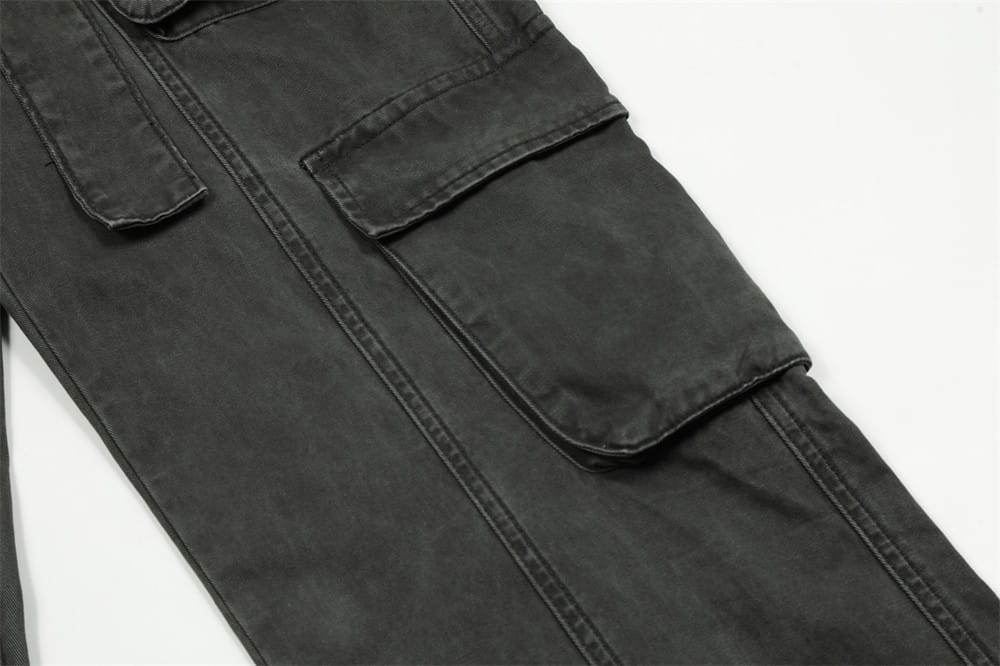 Salopettes cargo en jean de coton noir à coupe slim pour homme, avec plusieurs poches à rabat et des coutures renforcées.
