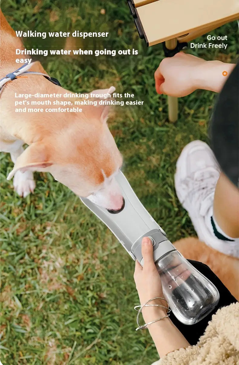 Silver and transparent plastic portable pet water bottle with carbon filter featuring a wide walking trough designed for pets.