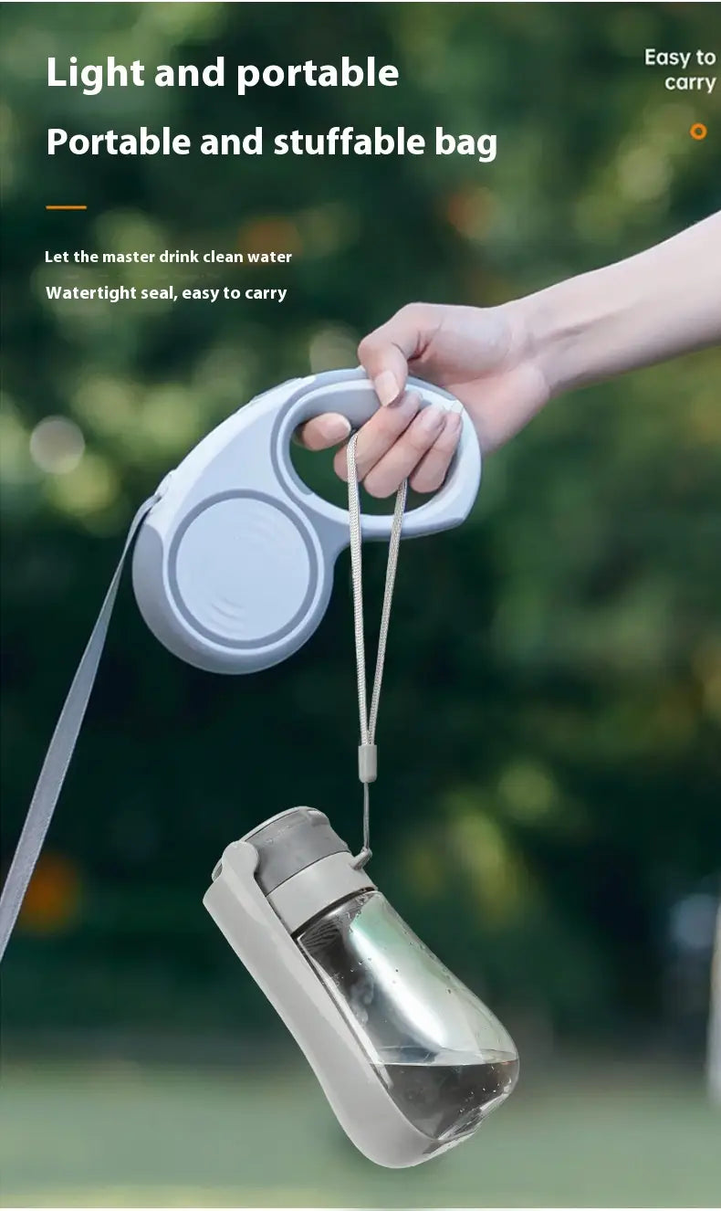 Portable pet water bottle with carbon filter featuring a light gray retractable leash-style design, transparent glass body, and white plastic cap for easy portability.
