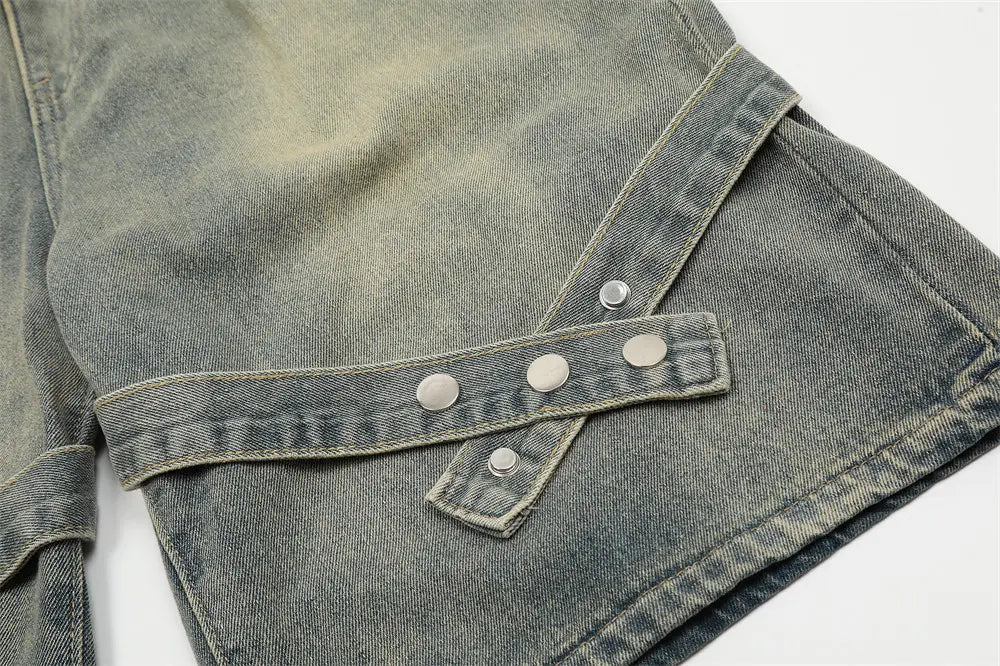 Veste en jean gris délavé, avec une fermeture à rabat distinctive fixée par trois boutons à tonalité argentée, assortie à des shorts en jean pour hommes à bretelles diagonales et taille à cordon.
