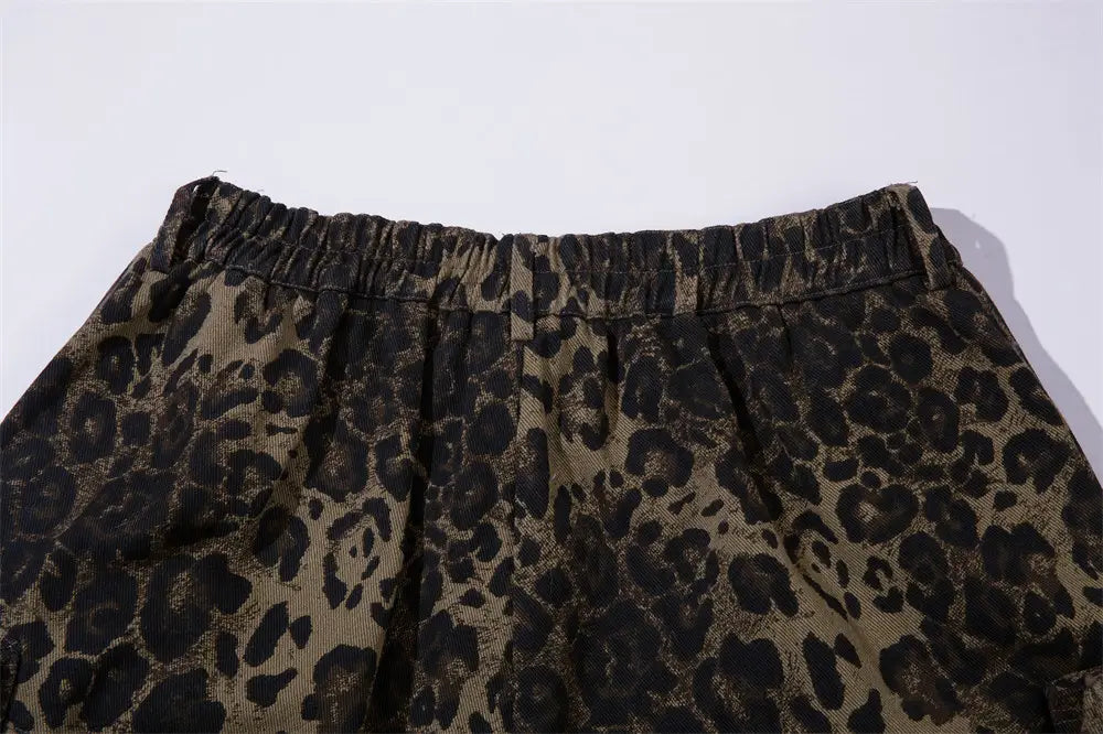 Men’s leopard print denim and cargo workwear shorts in black and tan with a leopard-print pleated design and an elastic waistband.