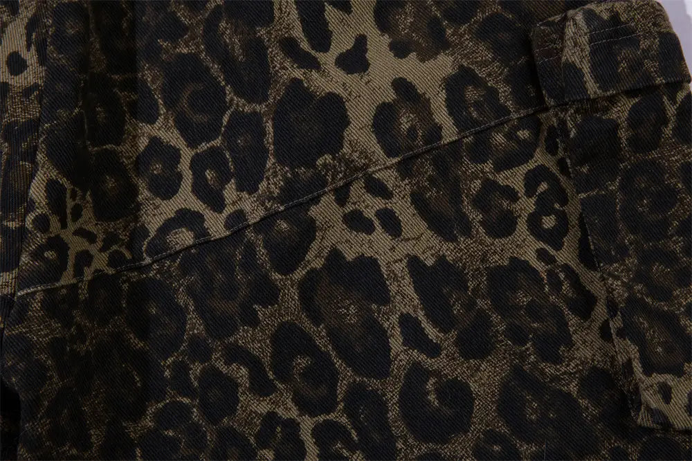 Men’s leopard print denim and cargo workwear shorts featuring dark brown and black leopard print fabric with a textured corduroy-like weave.