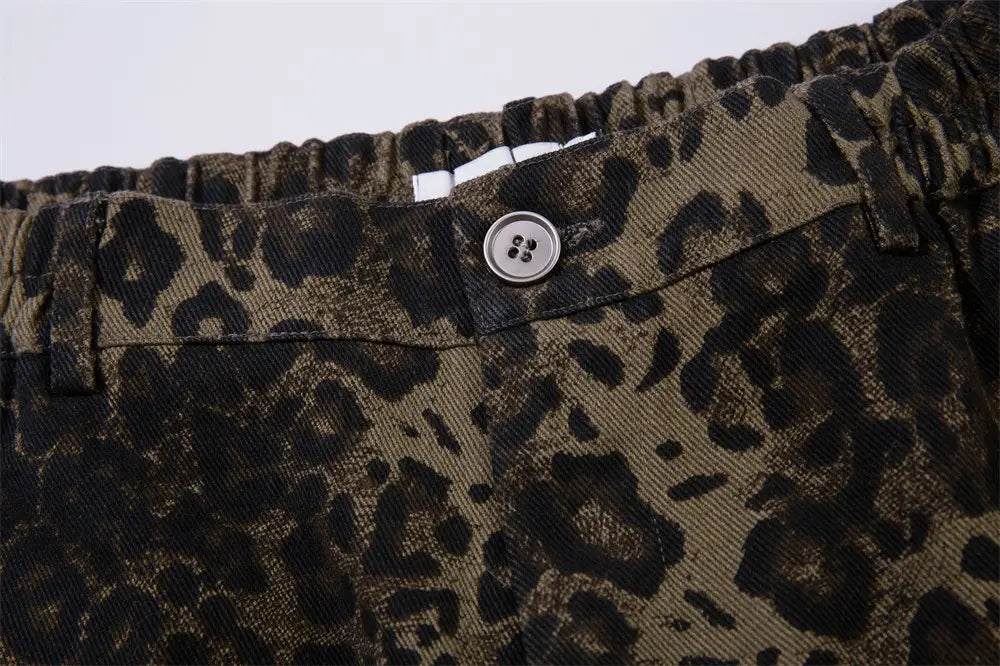 Men’s olive green and black leopard print denim and cargo workwear shorts featuring a silver four hole button.