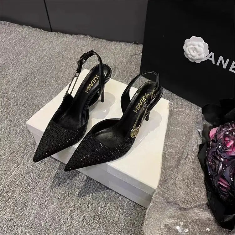 Black kween brand black rhinestone slingback stiletto heels featuring a pointed toe, sparkling mesh upper, and slender high heel.