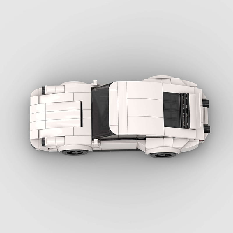 White lego model of a Porsche 911 classic sports car with black windows and wheels in a building block design.