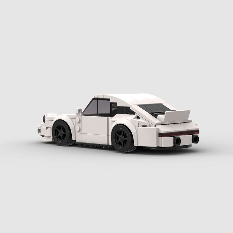 white lego Porsche 911 sports car building block model with black wheels and a rear spoiler viewed from the back side