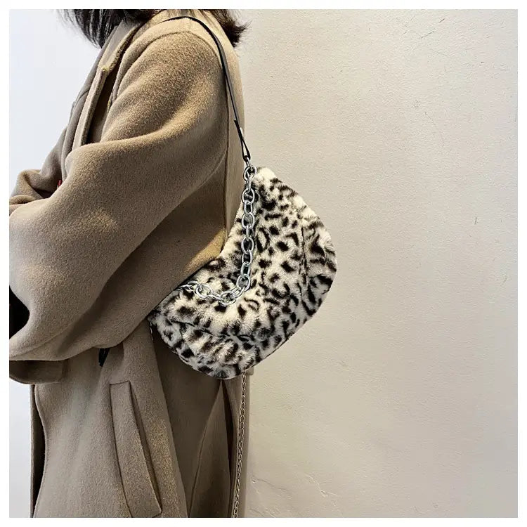 plush animal print baguette bag featuring a faux fur leopard print and a silver chain strap for crossbody use
