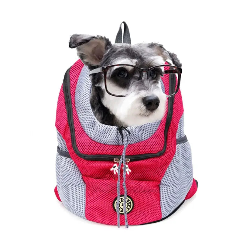 A breathable mesh pet carrier backpack for travel in pink and gray with black trim made of mesh material featuring a front zipper closure with small white tassels.