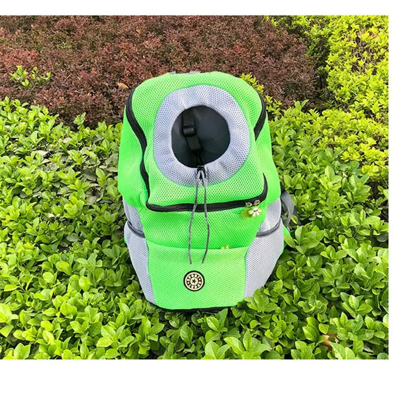 Bright green and gray breathable mesh pet carrier backpack with a circular opening at the top for travel.