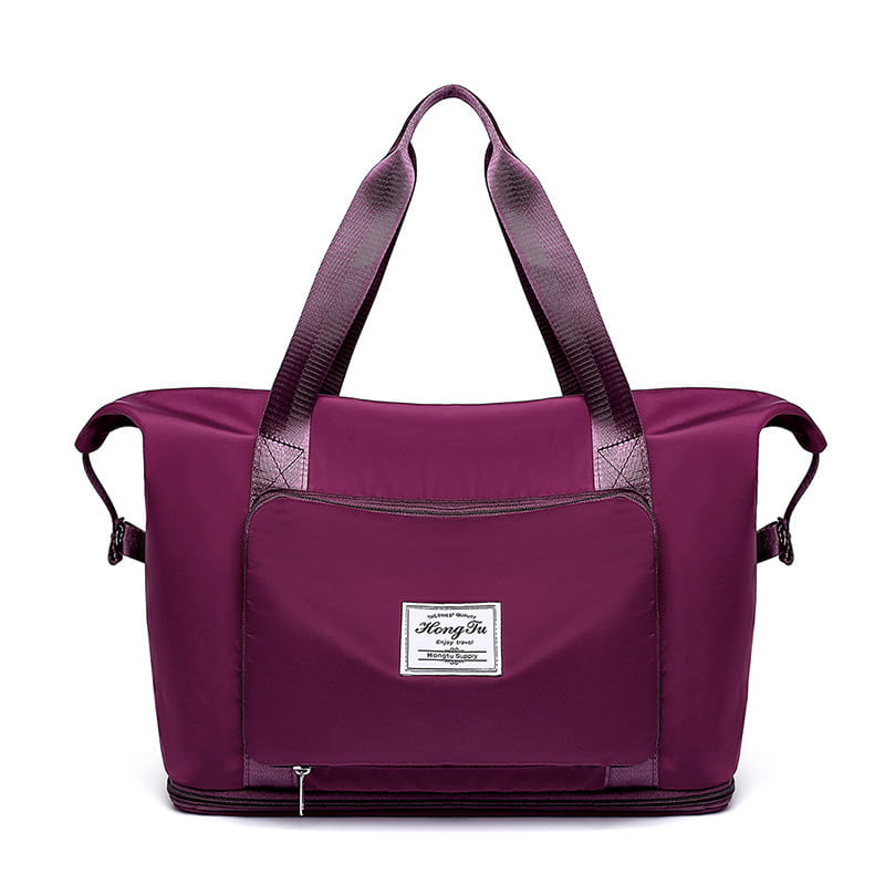 Purple nylon foldable gym bag with waterproof travel duffel design featuring reinforced handles and a branded patch on the front with shoe pocket.