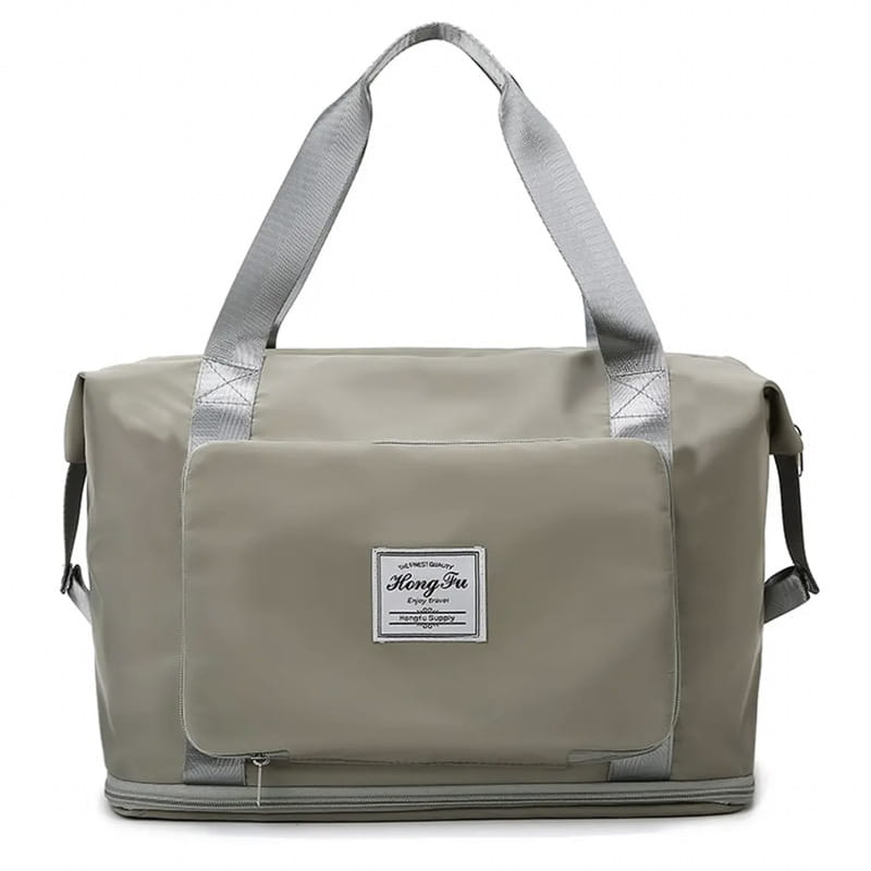 Beige foldable gym bag waterproof travel duffel with gray reinforced handles and a white label patch featuring a shoe pocket.