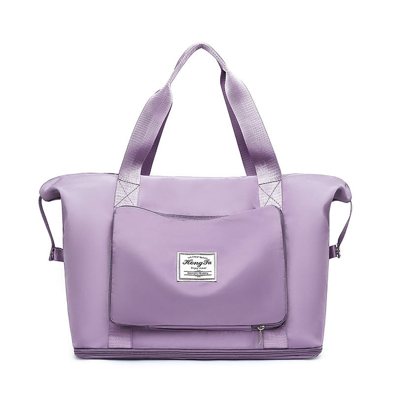 Lavender-colored lightweight nylon foldable gym bag with reinforced handles front zippered pocket white label and waterproof travel duffel with shoe pocket.