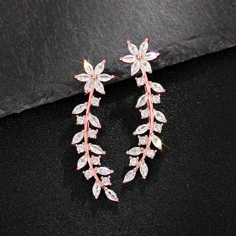 Rose gold vine ear climber earrings for women adorned with clear faceted crystals in a delicate floral design.