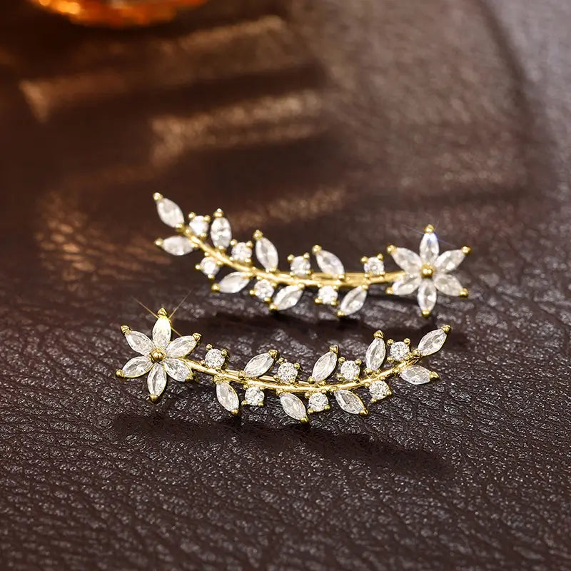 Gold-toned crystal floral vine ear climber earrings for women featuring a delicate vine design adorned with clear marquise and round-cut crystals.