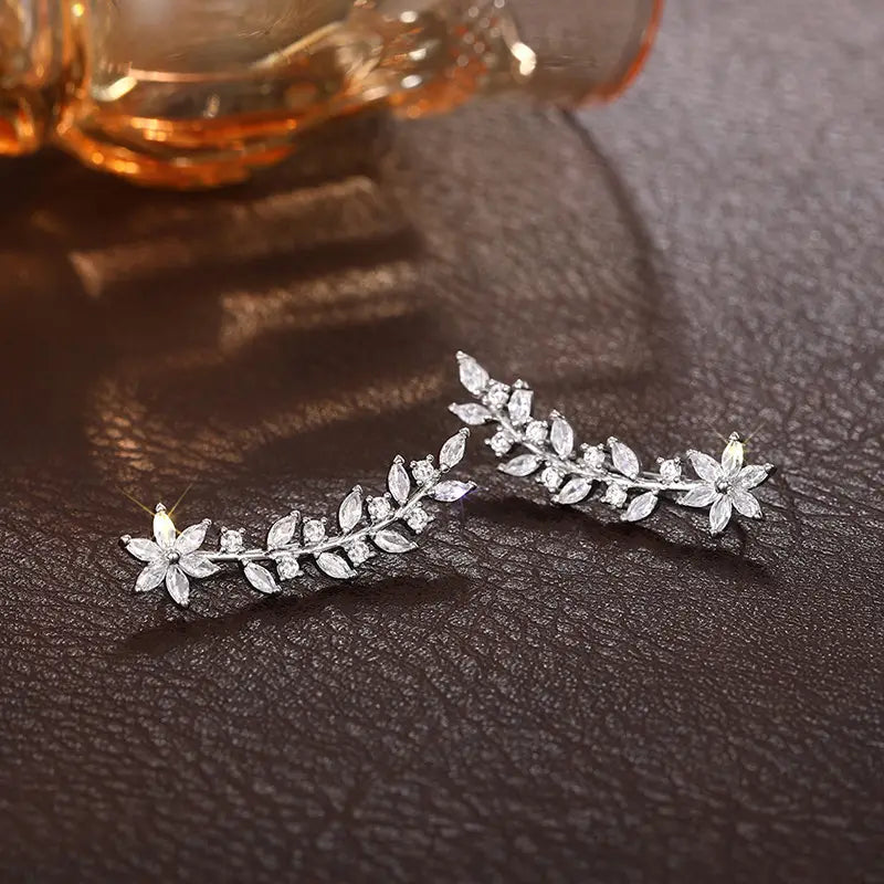 Crystal floral vine ear climber earrings for women in silver shaped like vines with clear crystals and delicate leaf motifs