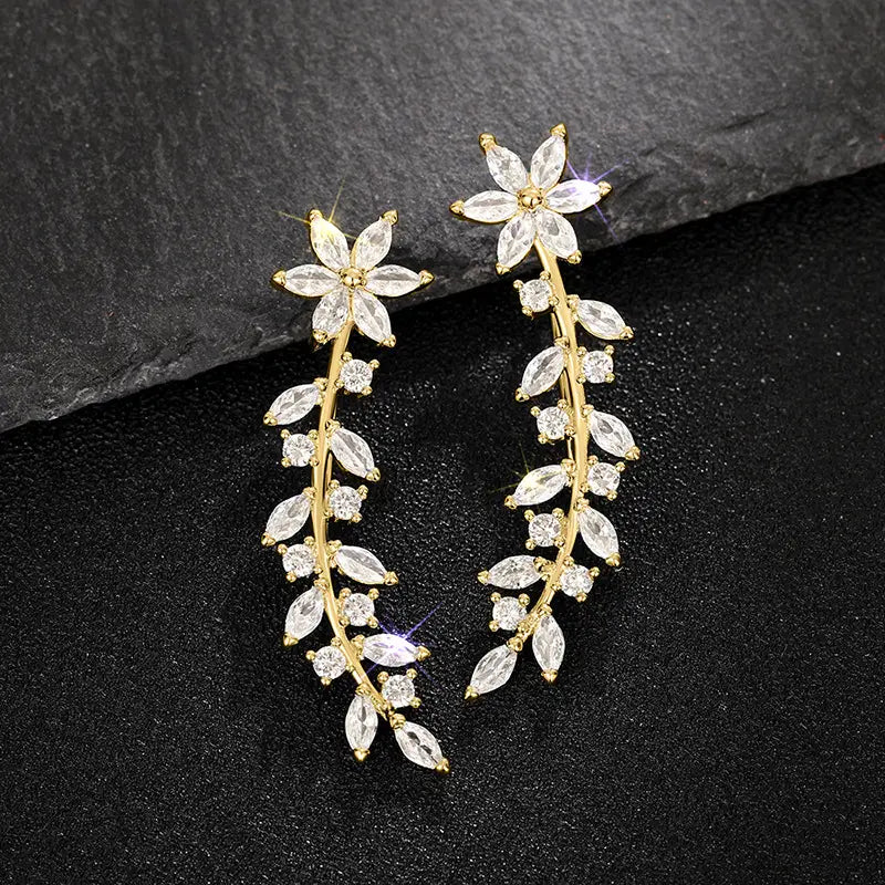 Crystal floral vine ear climber earrings for women featuring gold-toned metal adorned with clear faceted crystals.