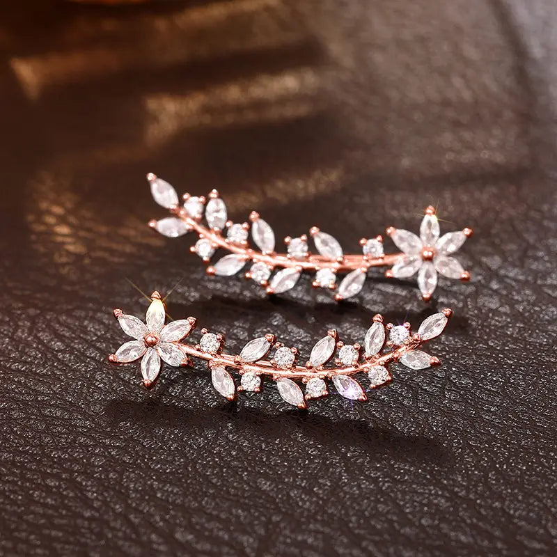 Rose gold-toned crystal floral vine ear climber earrings for women featuring clear marquise and round-cut crystals in a delicate leafy design.
