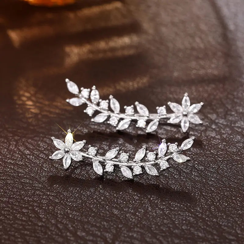 Crystal floral vine ear climber earrings for women featuring silver leaf and flower design adorned with clear crystals.